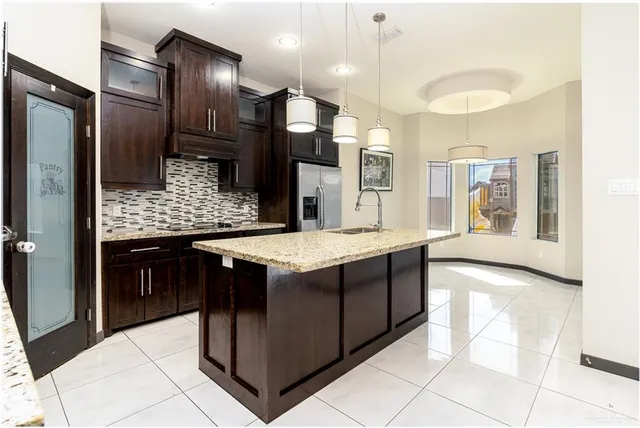 a kitchen with stainless steel appliances granite countertop a stove and a sink