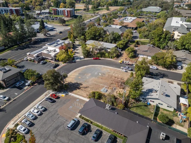an aerial view of residential houses with outdoor space