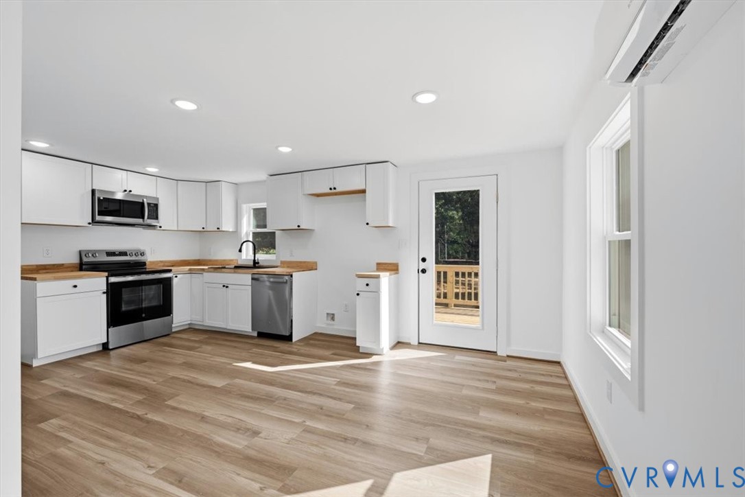 15221 Wright Road Amelia Court House, VA 23002 - Photo 9 of 22 Open-concept kitchen featuring white cabinetry, wo