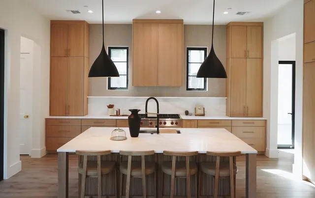 a kitchen with a sink a stove and chairs