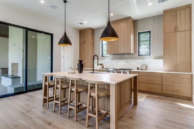a kitchen with a table chairs sink and cabinets
