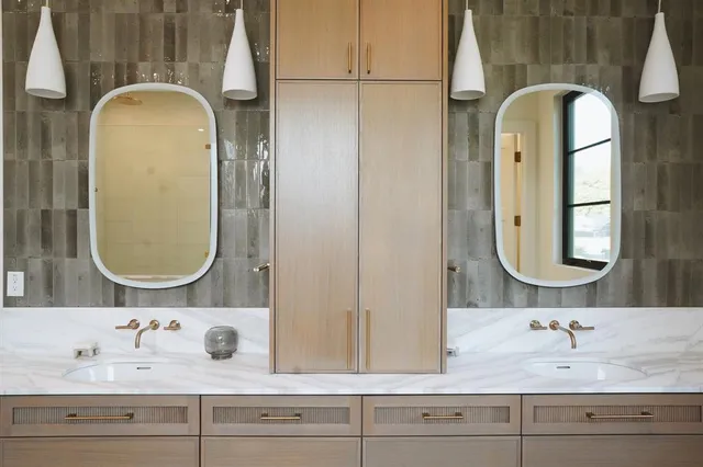 a bathroom with a double vanity sink and a mirror
