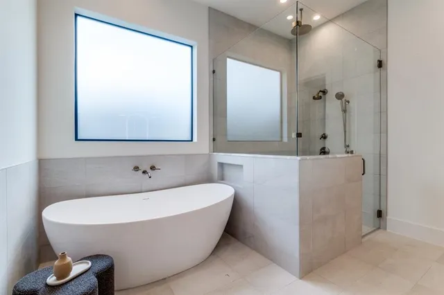 a bathroom with a bathtub and shower
