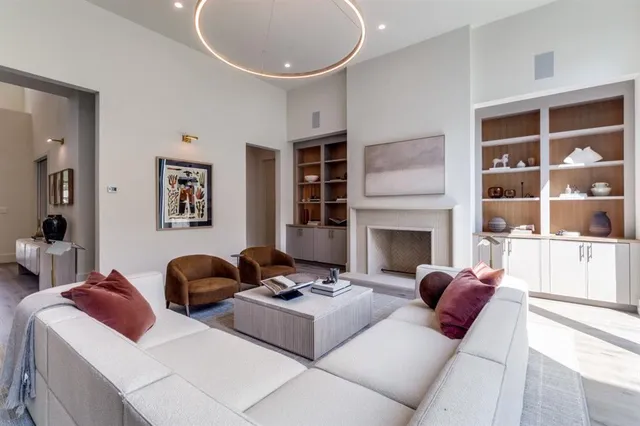 a living room with furniture a rug and a fireplace