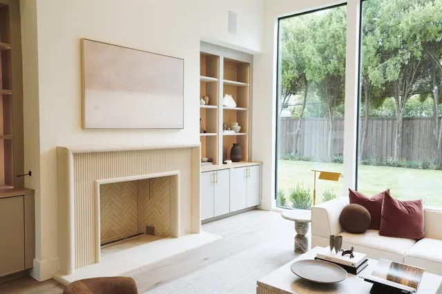 a living room with furniture and a floor to ceiling window