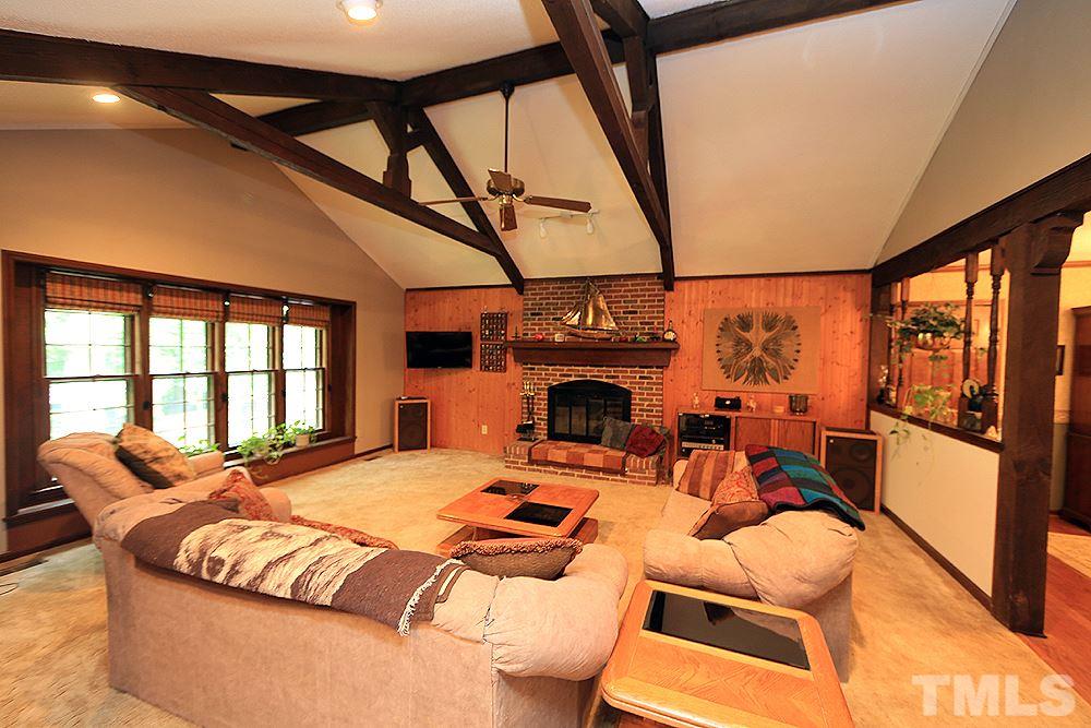 8009 Chadbourne Court Raleigh, NC 27613 - Photo 3 of 25 Spacious family room with fireplace, cathedral ceilings and wood beams.
