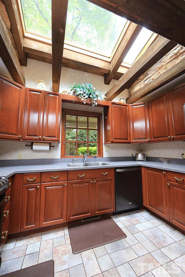 8009 Chadbourne Court Raleigh, NC 27613 - Photo 8 of 25 Skylights, stone accents and beams