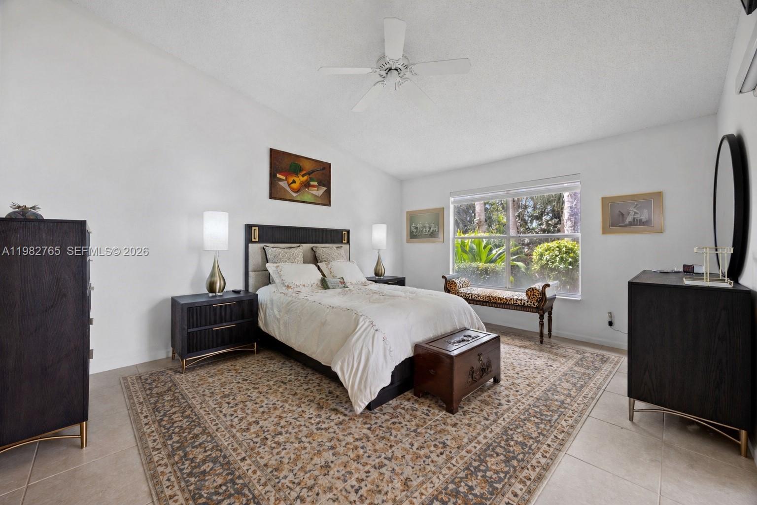 8962 Southeast Riverfront Terrace Jupiter, FL 33469 - Photo 7 of 20 a bedroom with a bed and a couch