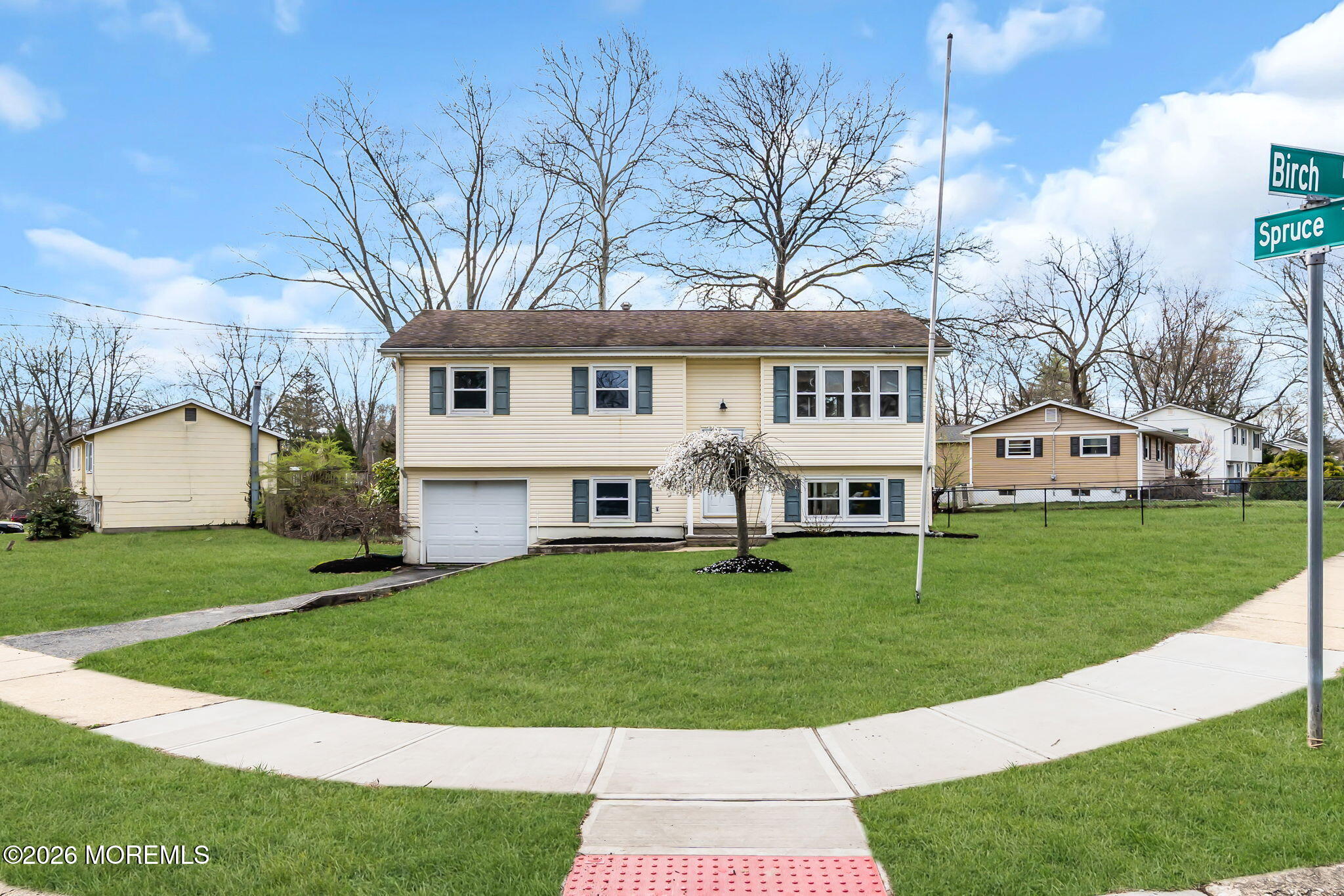 7 Spruce Terrace Jackson, NJ 08527 - Photo 1 of 49 a front view of a house with a garden and trees