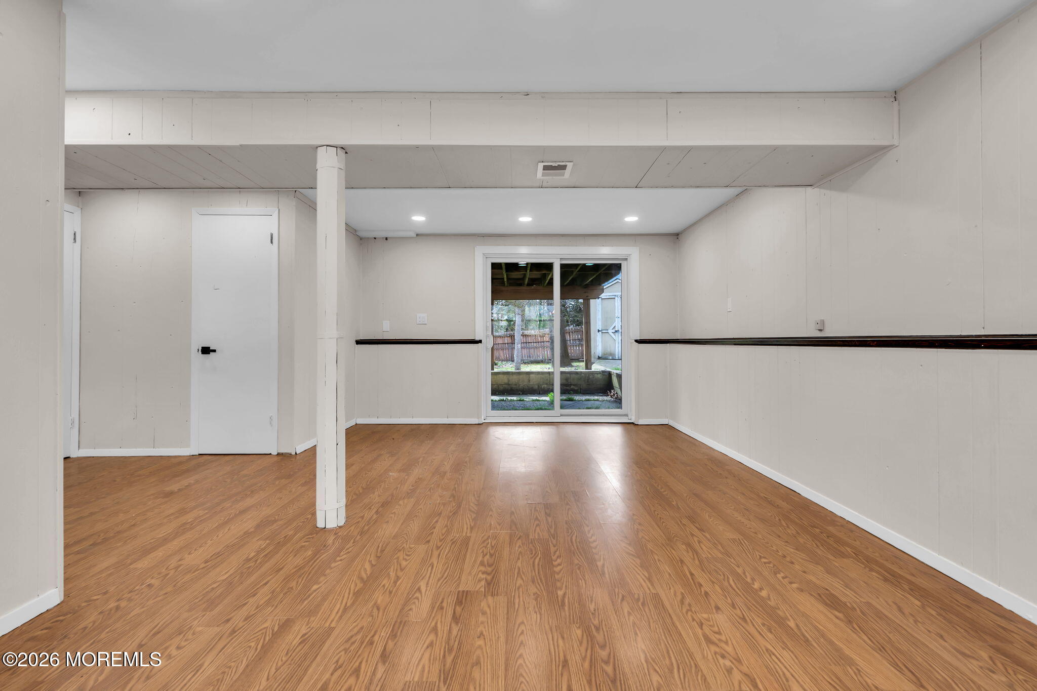 7 Spruce Terrace Jackson, NJ 08527 - Photo 40 of 49 a view of empty room with wooden floor and kitchen view