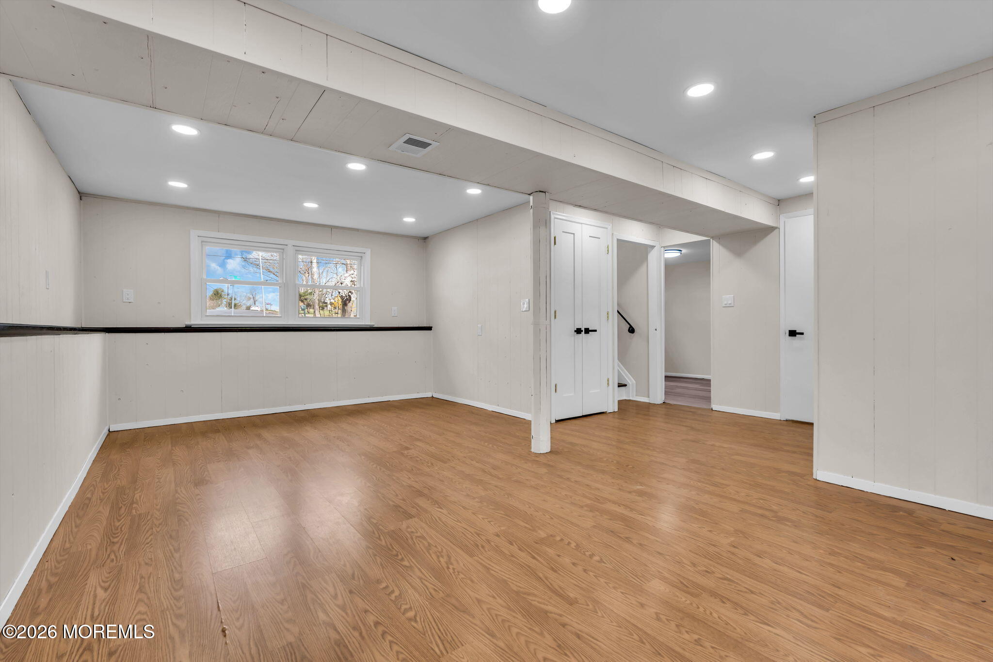 7 Spruce Terrace Jackson, NJ 08527 - Photo 41 of 49 a view of an empty room with wooden floor and a window