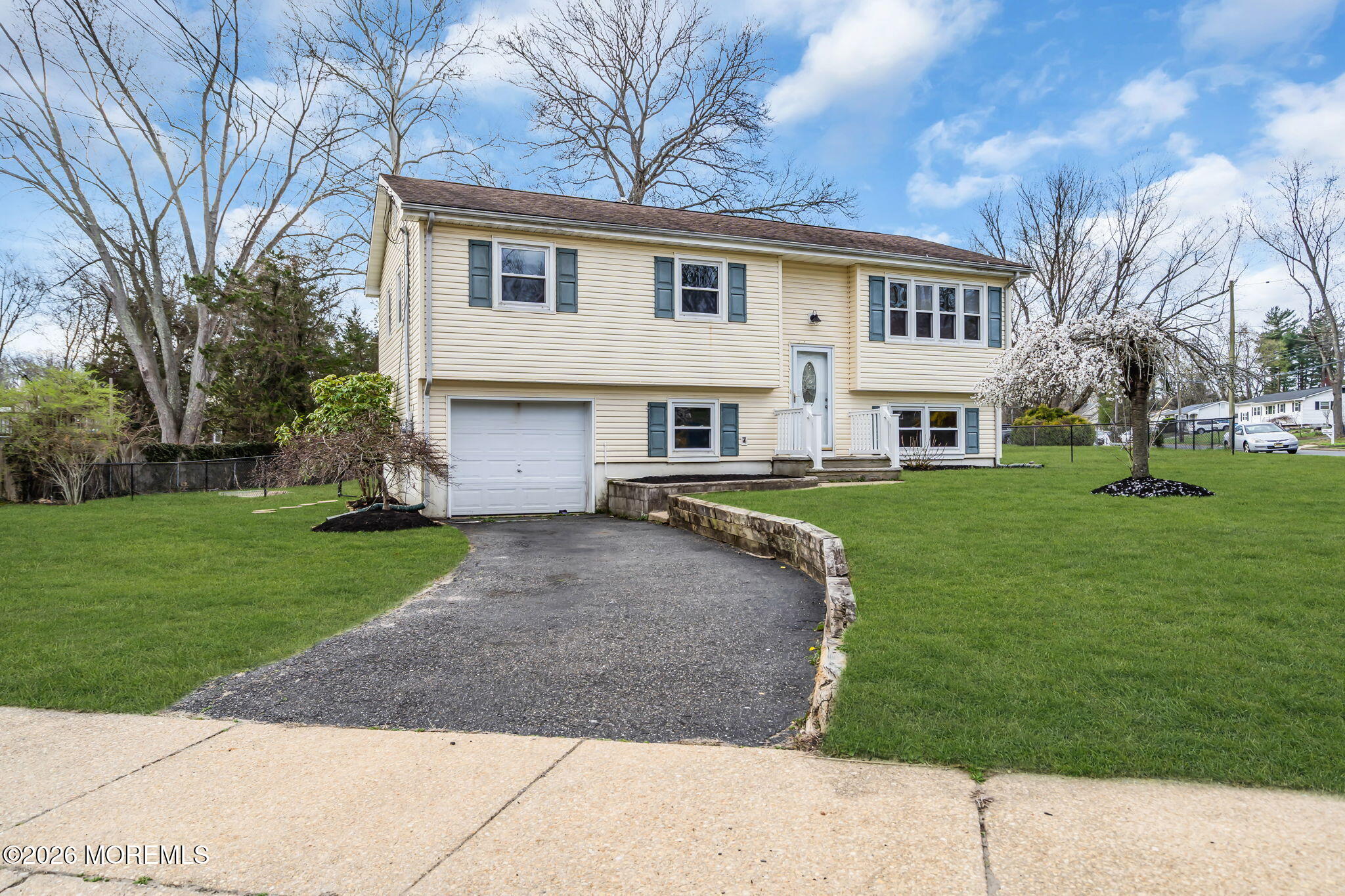 7 Spruce Terrace Jackson, NJ 08527 - Photo 6 of 49 a view of a white house with a yard and a large tree