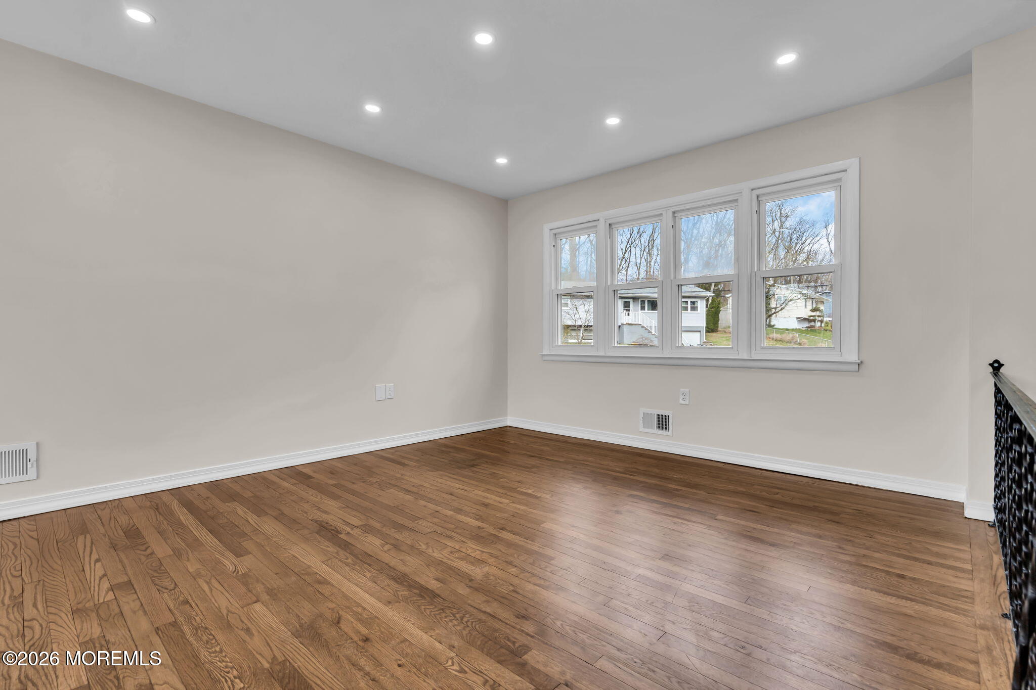 7 Spruce Terrace Jackson, NJ 08527 - Photo 10 of 49 a view of an empty room with wooden floor and a window