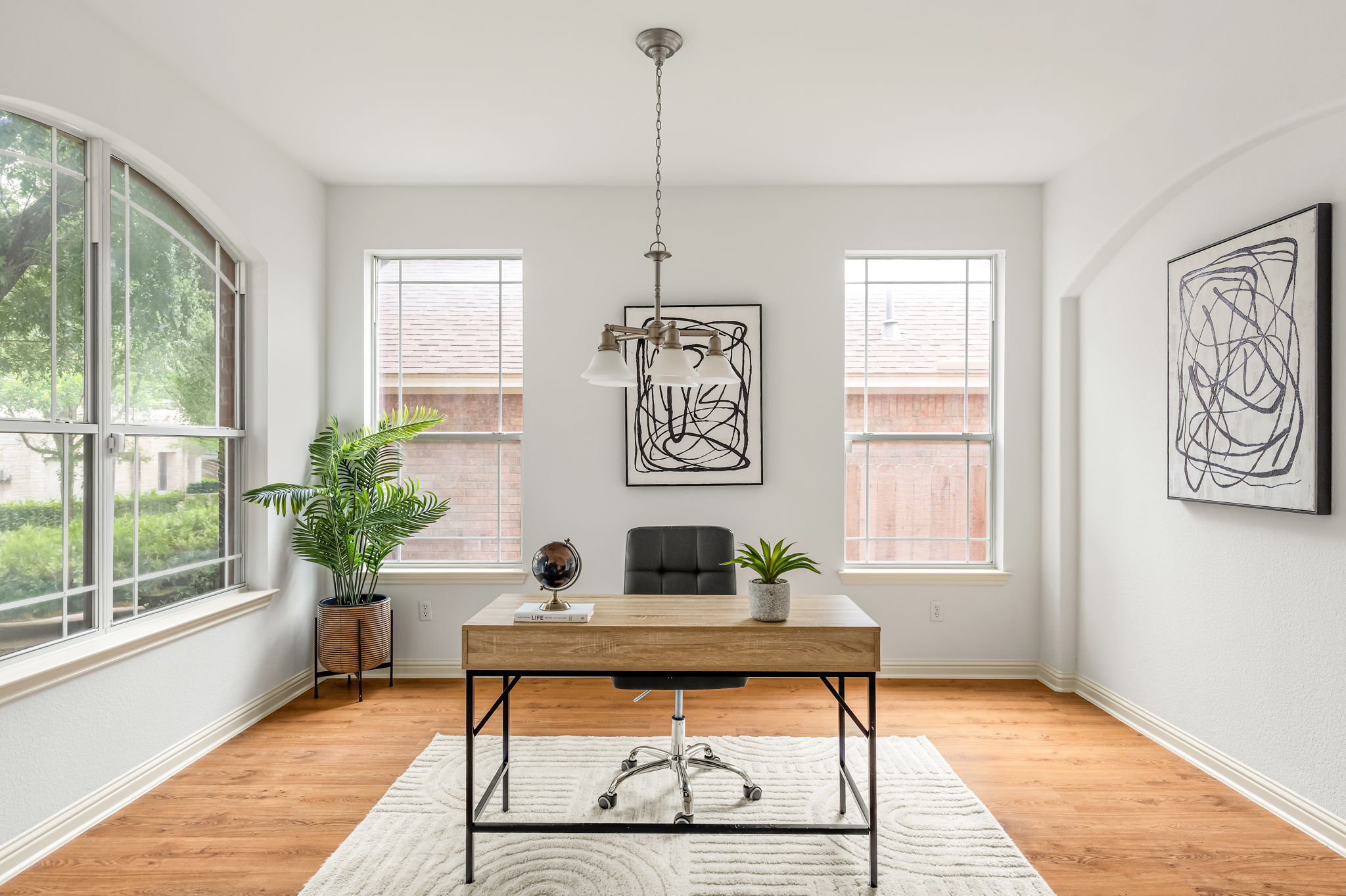 10004 Isle Royale Way Austin, TX 78747 - Photo 5 of 31 An airy office space bathed in natural light features gleaming hardwood flooring and a stylish pendant light fixture.