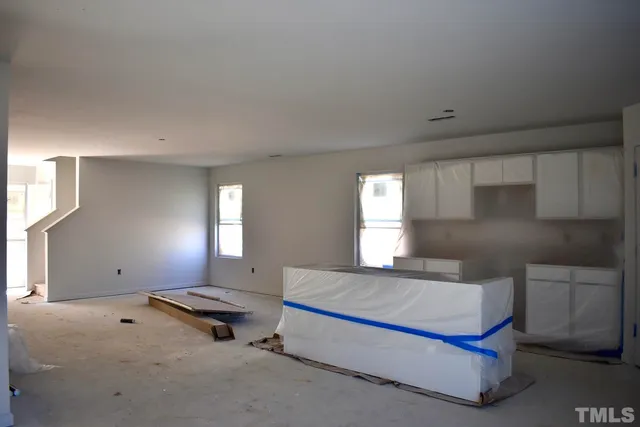 a spacious bedroom with a bed and window
