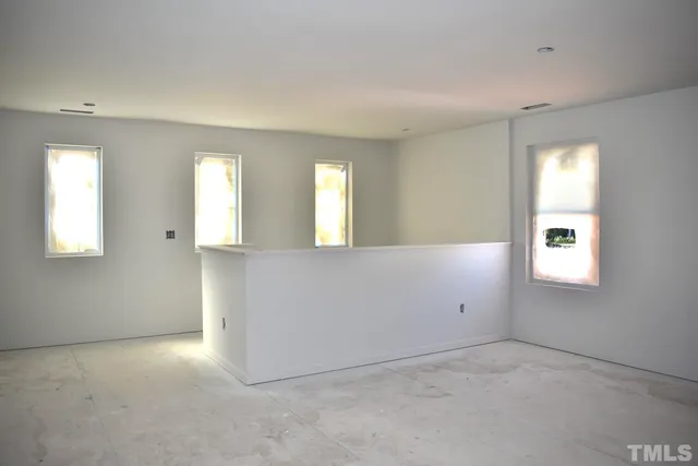 an empty room with windows and closet