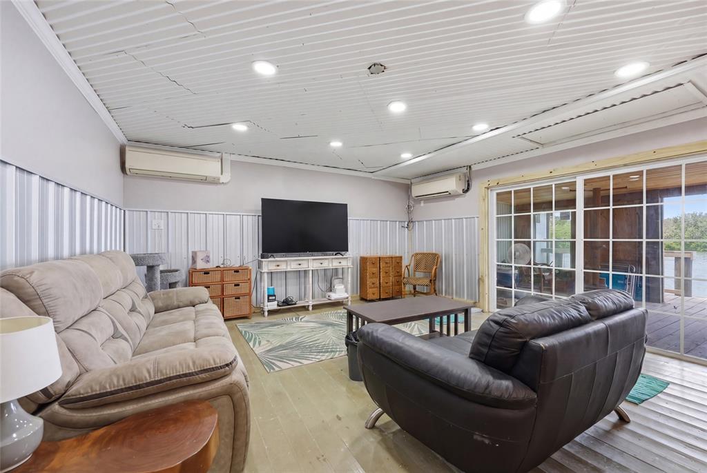 505 3rd Street Cedar Key, FL 32625 - Photo 16 of 37 a living room with furniture and a flat screen tv