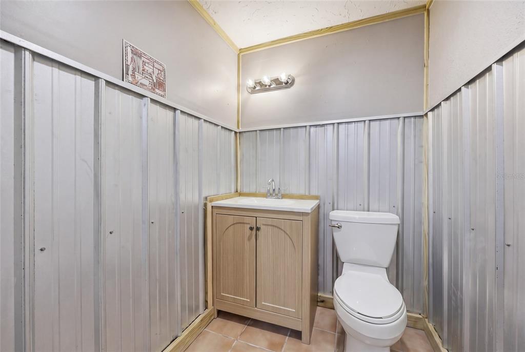 505 3rd Street Cedar Key, FL 32625 - Photo 21 of 37 a bathroom with a toilet a sink and shower