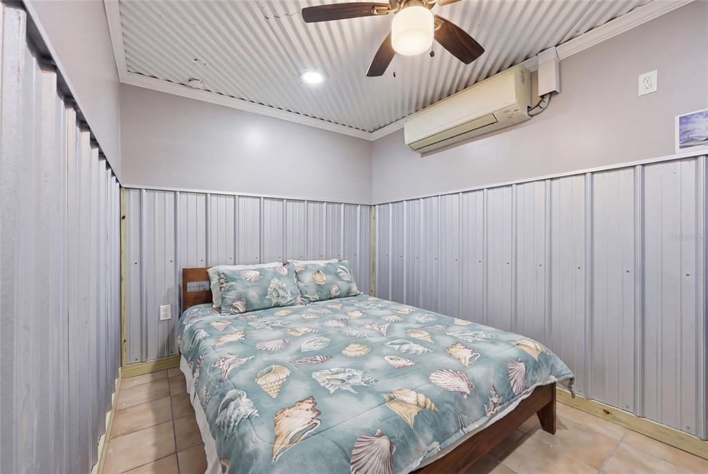 505 3rd Street Cedar Key, FL 32625 - Photo 23 of 37 a bedroom with a bed and a window