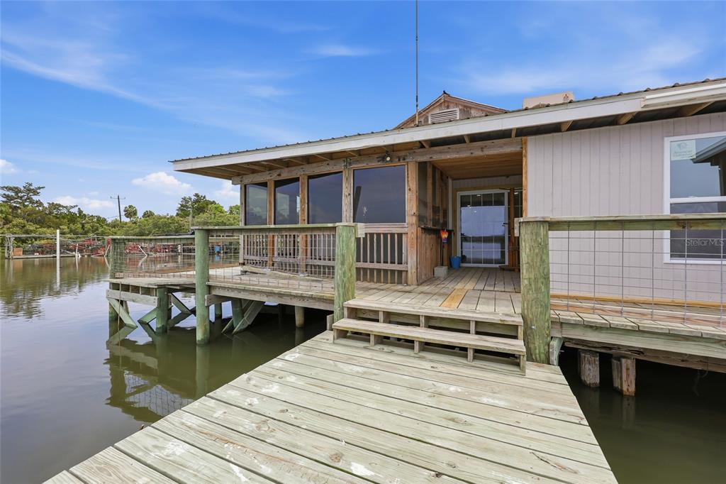505 3rd Street Cedar Key, FL 32625 - Photo 3 of 37 a roof deck with a table and a barbeque