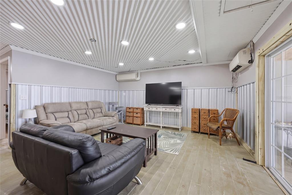 505 3rd Street Cedar Key, FL 32625 - Photo 7 of 37 a living room with furniture and a flat screen tv