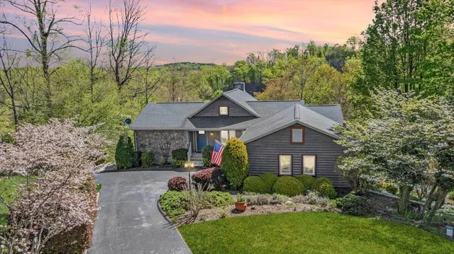 a backyard of a house with table and chairs