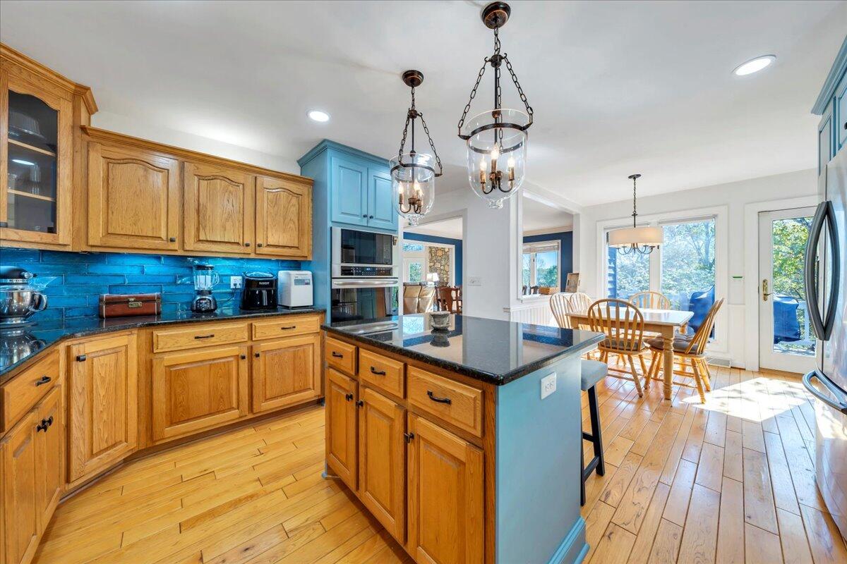 270 Forest Edge Road Wirtz, VA 24184 - Photo 21 of 79 a kitchen with stainless steel appliances granite countertop a kitchen island a stove a table and chairs in it