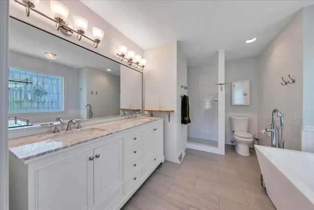 a living room with a bed furniture and a window