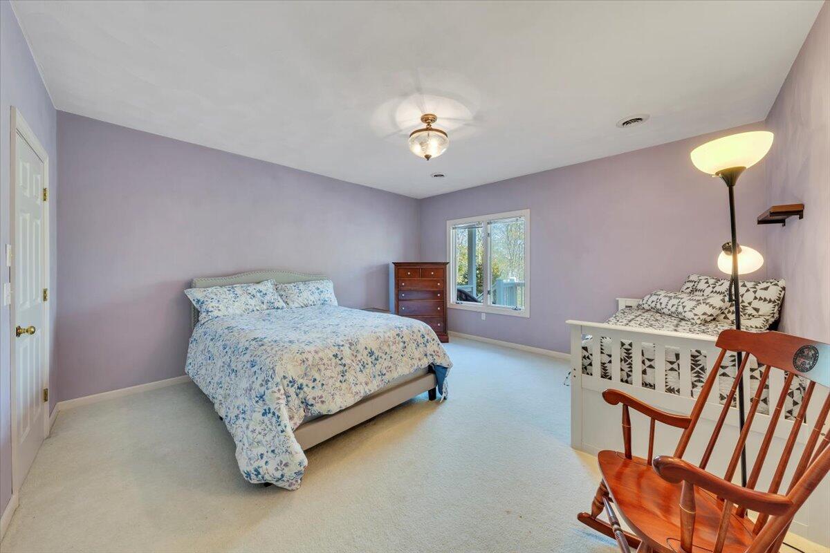 270 Forest Edge Road Wirtz, VA 24184 - Photo 41 of 79 a bedroom with a bed and a chandelier