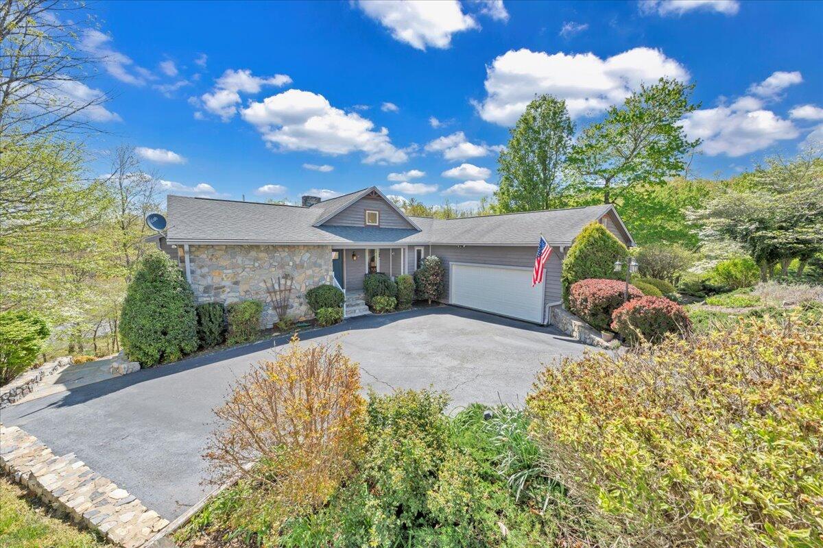 270 Forest Edge Road Wirtz, VA 24184 - Photo 75 of 79 a front view of a house with a yard and a garden