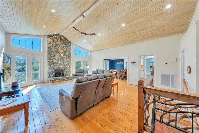 a living room with furniture kitchen view and a large window