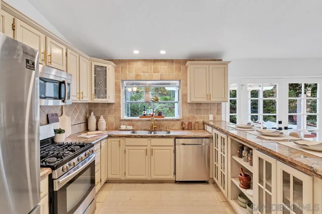12731 Stone Canyon Road Poway, CA 92064 - Photo 13 of 44 a kitchen with a sink stove and cabinets