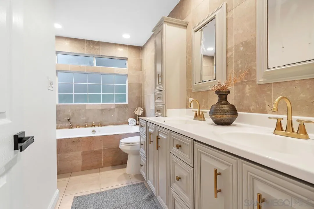 12731 Stone Canyon Road Poway, CA 92064 - Photo 17 of 44 a bathroom with a tub sink and mirror