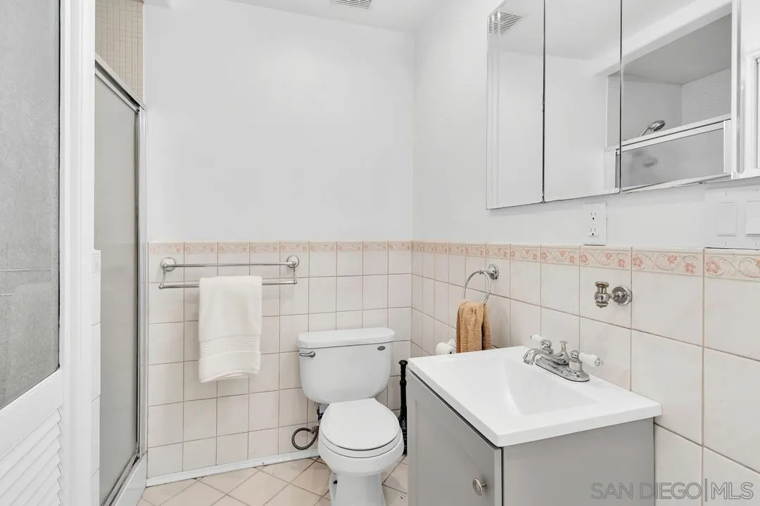 12731 Stone Canyon Road Poway, CA 92064 - Photo 20 of 44 a bathroom with a sink a toilet and a mirror