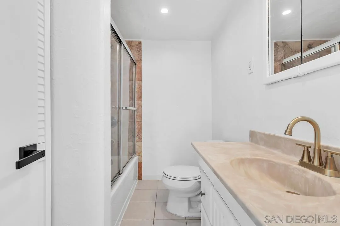 12731 Stone Canyon Road Poway, CA 92064 - Photo 22 of 44 a bathroom with a granite countertop sink toilet and shower