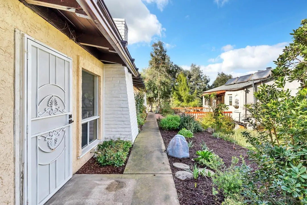 12731 Stone Canyon Road Poway, CA 92064 - Photo 28 of 44 a view of a pathway of a house with backyard and plants