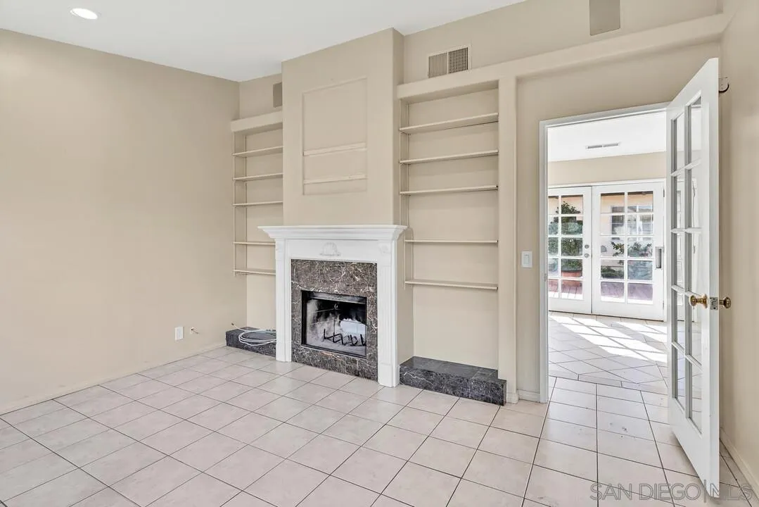 12731 Stone Canyon Road Poway, CA 92064 - Photo 33 of 44 a view of an empty room with a fireplace and a window
