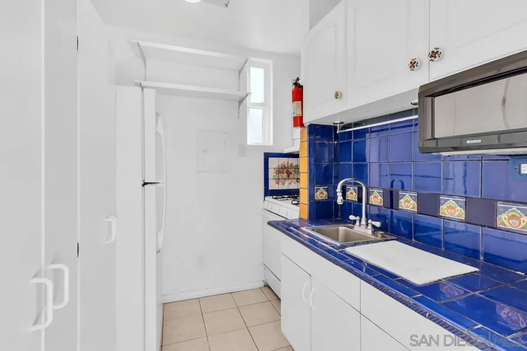 12731 Stone Canyon Road Poway, CA 92064 - Photo 35 of 44 a kitchen with stainless steel appliances granite countertop a sink stove and cabinets