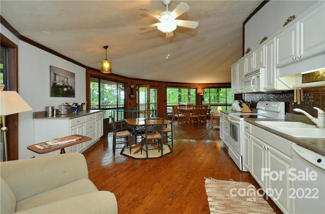 55 Summit Road Tryon, NC 28782 - Photo 11 of 23 a living room with furniture a flat screen tv and a large window