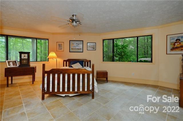 55 Summit Road Tryon, NC 28782 - Photo 16 of 23 a bedroom with furniture and a large window