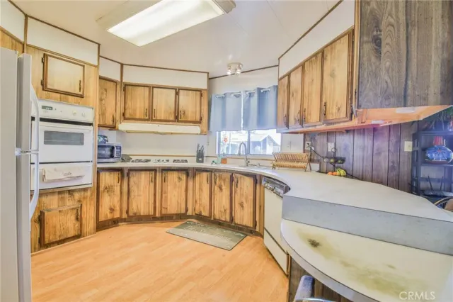 a kitchen with a refrigerator a sink and a cabinets