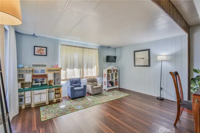 a living room with furniture window and wooden floor