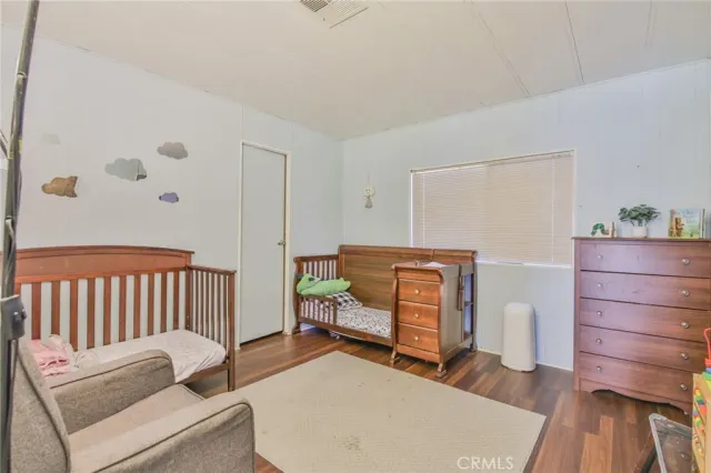 a bedroom with furniture and wooden floor
