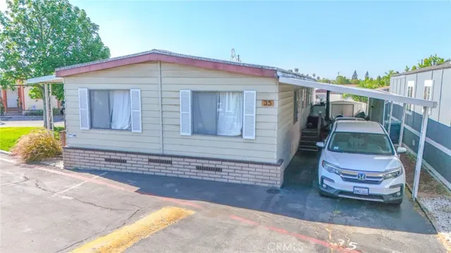 a front view of a house with outdoor seating