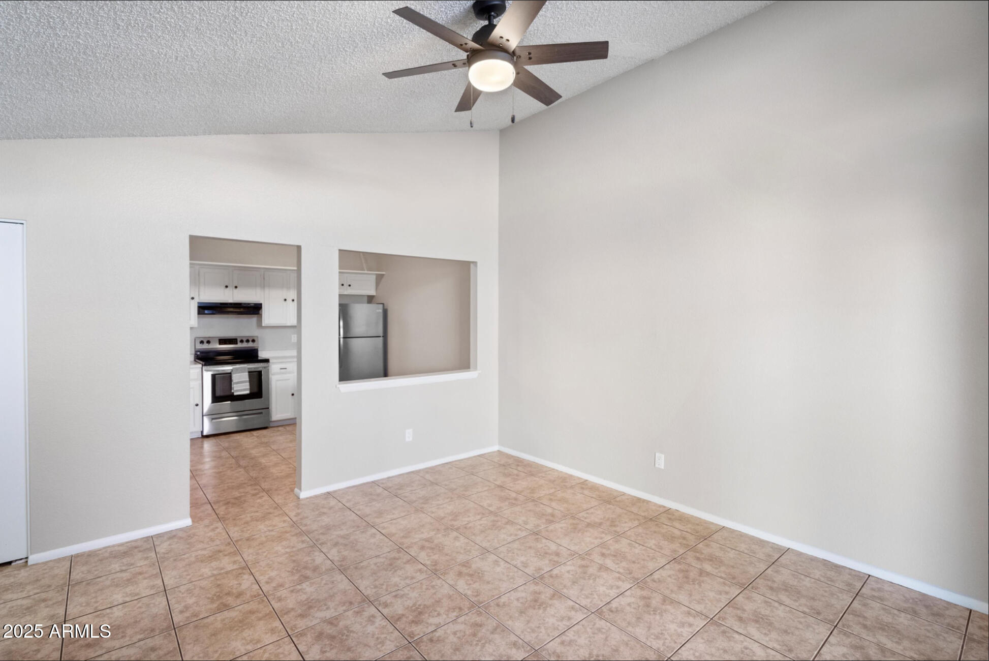555 North May, Unit 23 Mesa, AZ 85201 - Photo 12 of 19 an empty room with a empty space and a ceiling fan