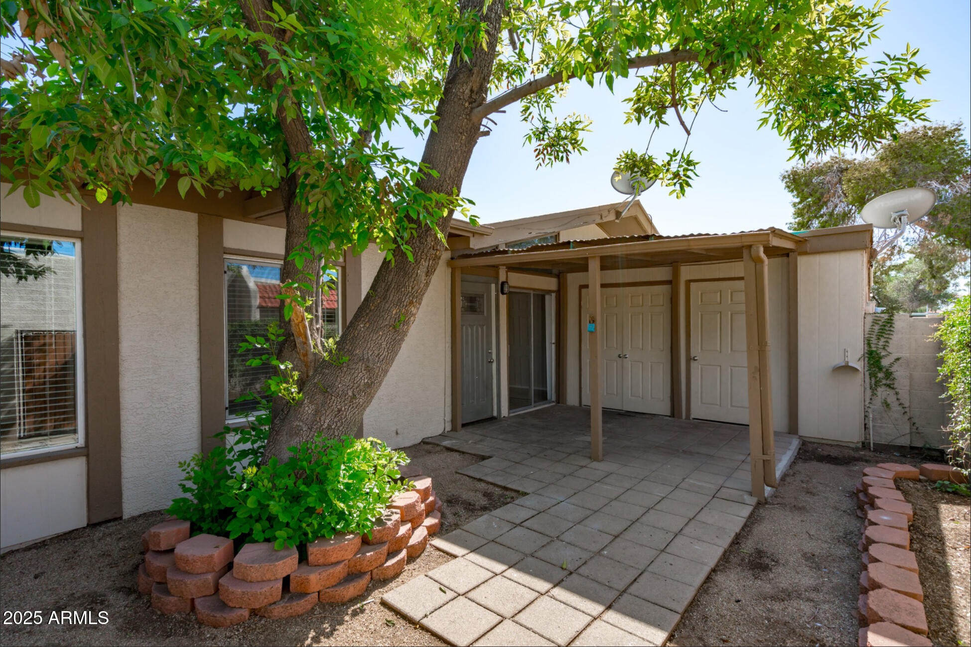 555 North May, Unit 23 Mesa, AZ 85201 - Photo 17 of 19 a front view of a house with a garden