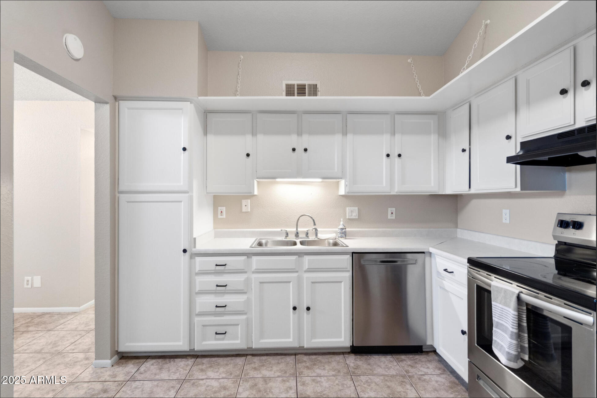 555 North May, Unit 23 Mesa, AZ 85201 - Photo 7 of 19 a kitchen with cabinets appliances and a sink