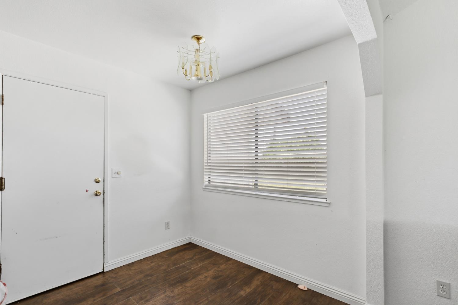 7208 7th Street Rio Linda, CA 95673 - Photo 12 of 41 a view of an empty room with wooden floor and a window