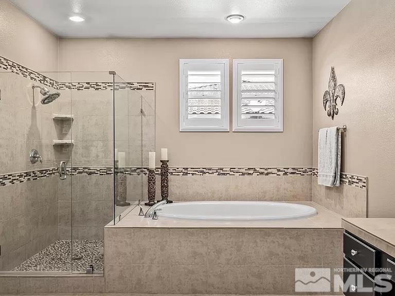 2725 Foxhunter Lane Reno, NV 89521 - Photo 11 of 25 a bathroom with a bathtub and shower