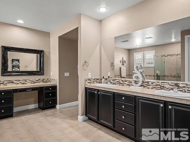 2725 Foxhunter Lane Reno, NV 89521 - Photo 12 of 25 a spacious bathroom with a granite countertop double vanity and a large mirror